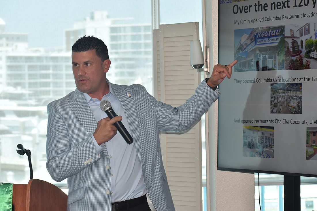 Casey Gonzmart Jr. explains a PowerPoint slide to the club.