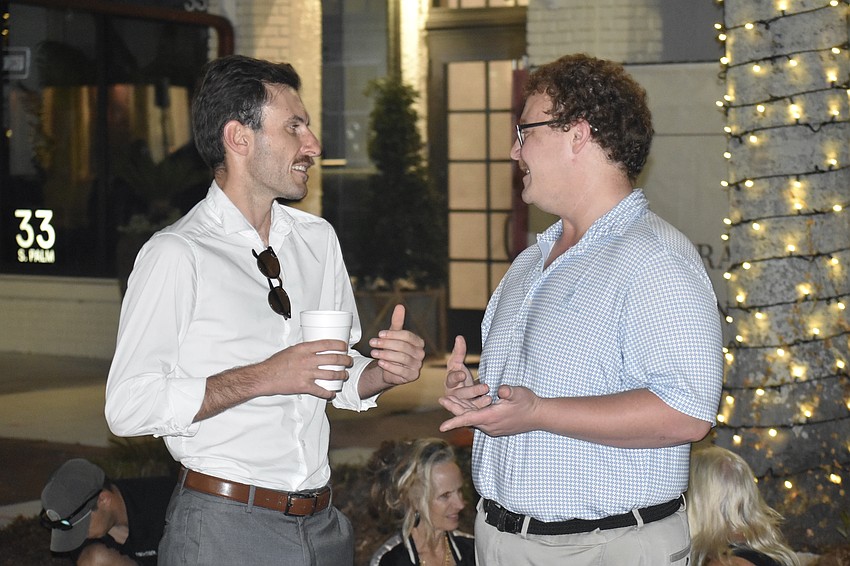 Artem Esayan and Jay Manson catch up after work.