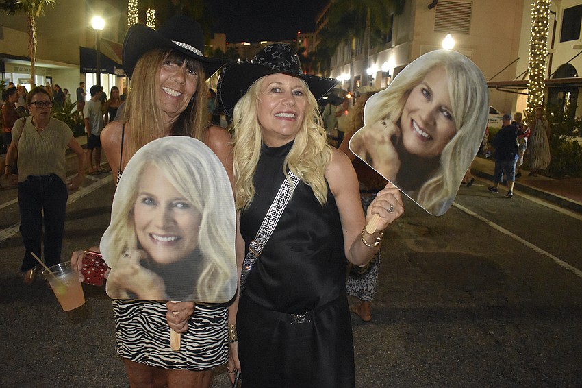 Lisa Donetti and Gina Love celebrate Love's 60th birthday, bringing cutouts of herself.
