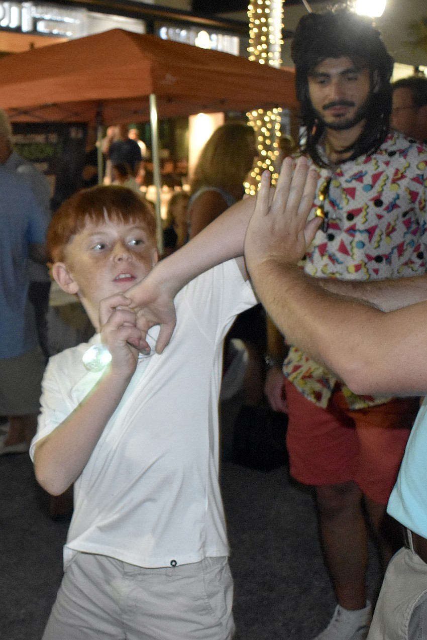Artem Esayan Jr., 8, a red belt in Taekwondo, practices the martial art, as Gabriel Grais looks on, with Adam Frazier.
