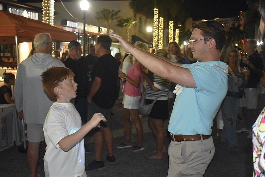 Artem Esayan Jr., 8, a red belt in Taekwondo, practices the martial art with Adam Frazier.