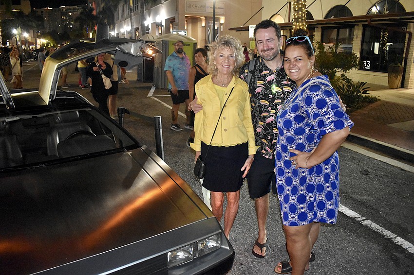Daniele Saint-Cyr, Serge Gauthier and Sonia Gauthier pay a visit to the DeLorean.