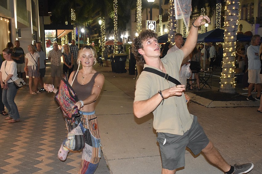 Shayla and Hunter Murphy bring the energy of flow stars, a type of juggling cloth, to the event.