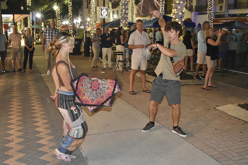 Shayla and Hunter Murphy bring the energy of flow stars, a type of juggling cloth, to the event.
