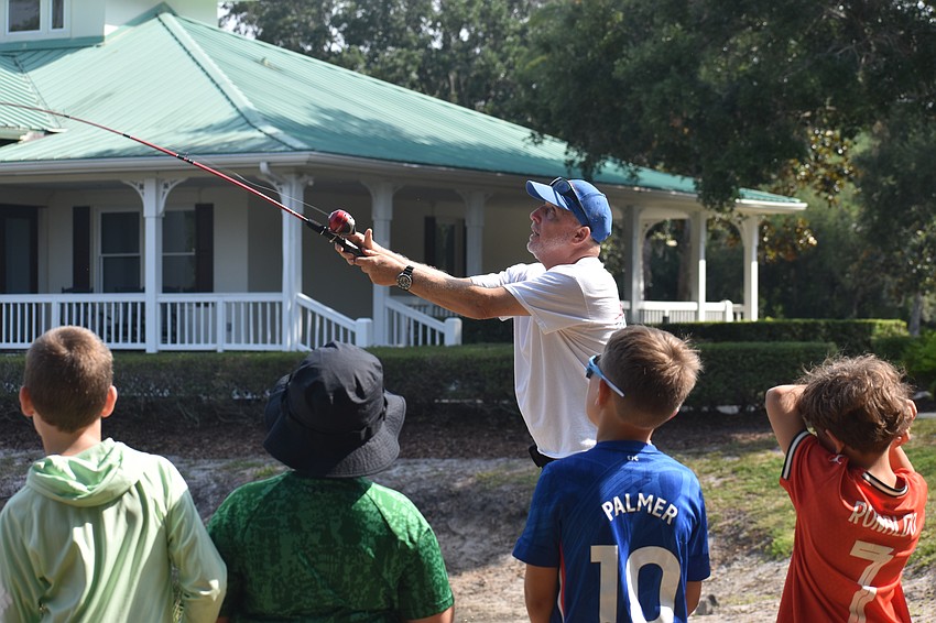 Ed Catalane, a member of the Lakewood Ranch Anglers Club, demonstrates how to cast a fishing rod for the Youth & Teen Fishing Seminar.
