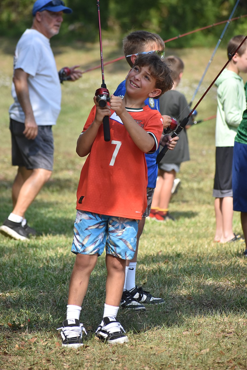 Lakewood Ranch's Wyatt Abajian, 8, successfully reels in his fishing line that got stuck in a tree at the Youth & Teen Fishing Seminar.