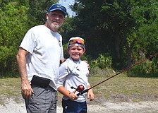 Ed Catalane of the Lakewood Ranch Anglers Club does his part to teach children, including Lakewood Ranch's Hayes Cochran, further their fishing skills at the Youth & Teen Fishing Seminar May 2.