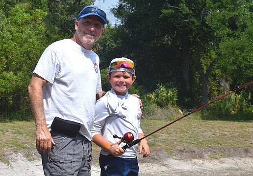 Ed Catalane of the Lakewood Ranch Anglers Club does his part to teach children, including Lakewood Ranch's Hayes Cochran, further their fishing skills at the Youth & Teen Fishing Seminar May 2.