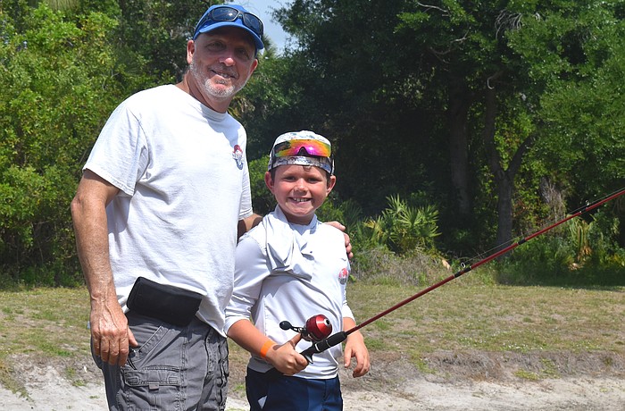 Ed Catalane of the Lakewood Ranch Anglers Club does his part to teach children, including Lakewood Ranch's Hayes Cochran, further their fishing skills at the Youth & Teen Fishing Seminar May 2.