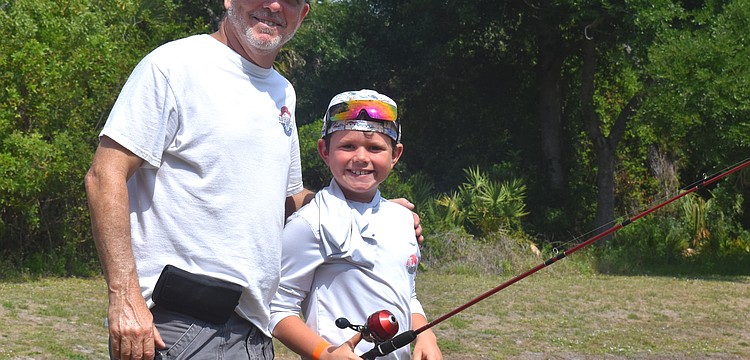 Ed Catalane of the Lakewood Ranch Anglers Club does his part to teach children, including Lakewood Ranch's Hayes Cochran, further their fishing skills at the Youth & Teen Fishing Seminar May 2.