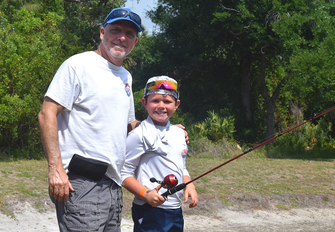 Ed Catalane of the Lakewood Ranch Anglers Club does his part to teach children, including Lakewood Ranch's Hayes Cochran, further their fishing skills at the Youth & Teen Fishing Seminar May 2.