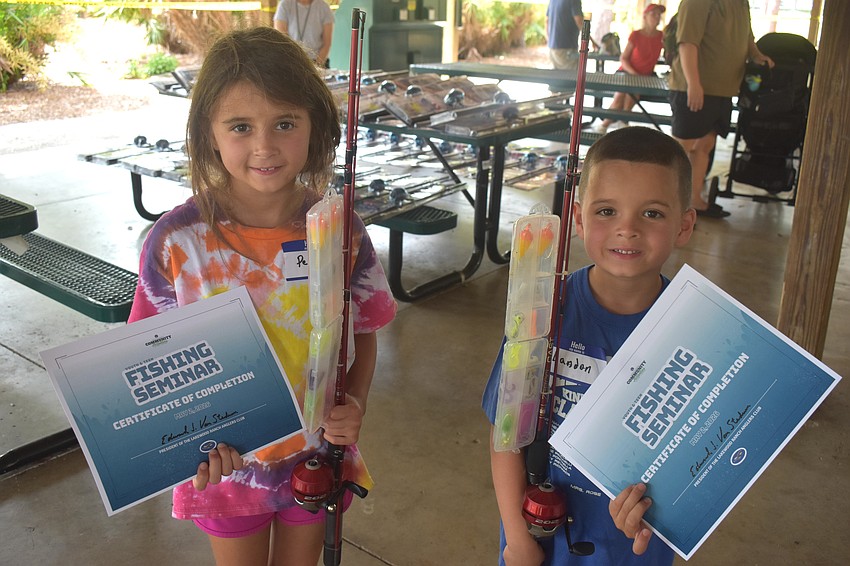 Lakewood Ranch's Penelope Caswell, 6, and Landon Caswell, 5, are happy to walk away with new fishing poles after completing the Youth & Teen Fishing Seminar put on by the Lakewood Ranch Anglers Club.