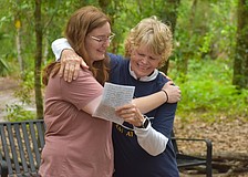 Carissa Smentowski, who played a big part in creating the Peaceful Path, receives a hug from the Peaceful Path Director Jamie Reagan during the World Labryrinth Day program.