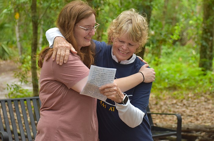 Carissa Smentowski, who played a big part in creating the Peaceful Path, receives a hug from the Peaceful Path Director Jamie Reagan during the World Labryrinth Day program.
