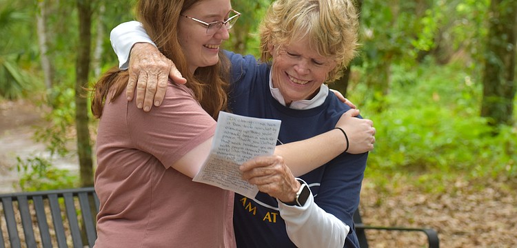 Carissa Smentowski, who played a big part in creating the Peaceful Path, receives a hug from the Peaceful Path Director Jamie Reagan during the World Labryrinth Day program.
