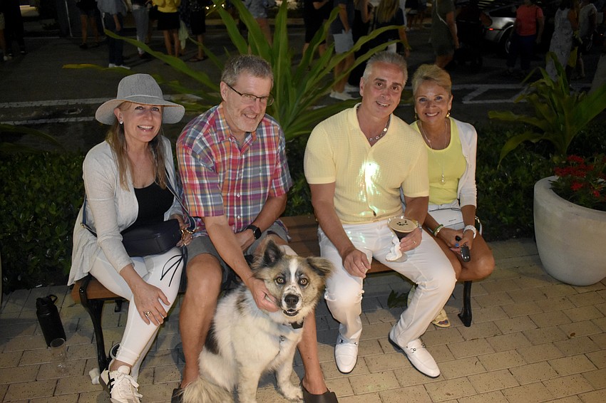 Catherine and Mark Kudlacik, their dog Cooper, and Craig and Alma Gloznek enjoy the atmosphere.