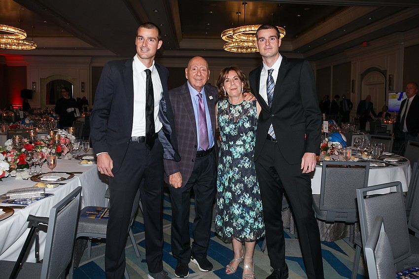 Recent Duke grads are Jake and Connor Krug who take a photo with their famous grandparents, Dick and Lorraine Vitale.