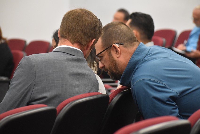 Attorney Kyle Grimes and Casto's Dan Moyer confer during the Feb. 12 commission meeting.