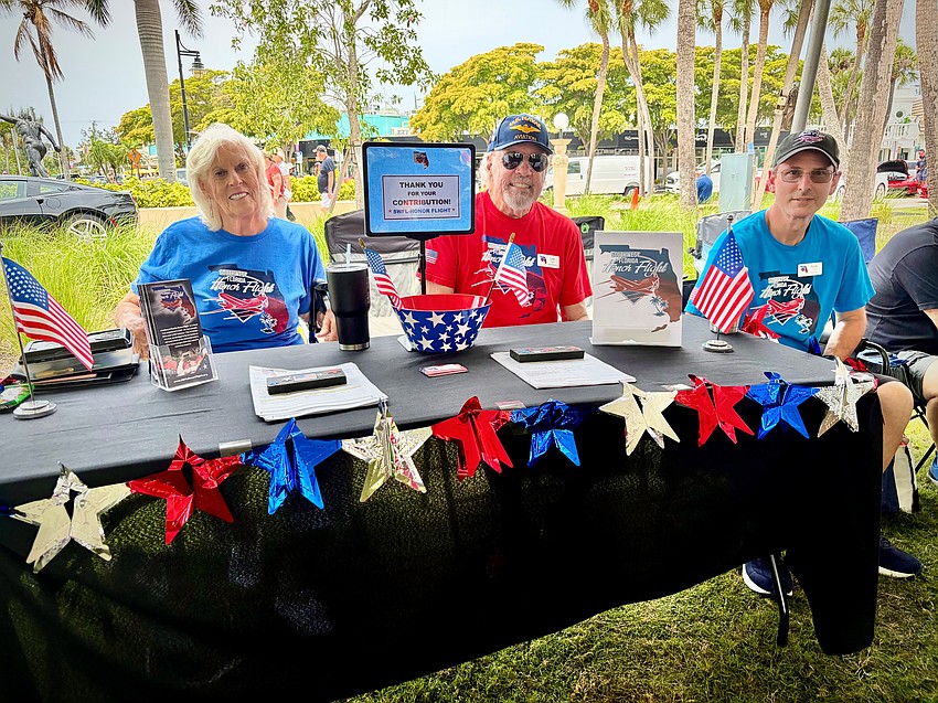 Joy and Lee Hale and Andy Shaw educate car show attendees about the Southwest Florida Honor Flight program.
