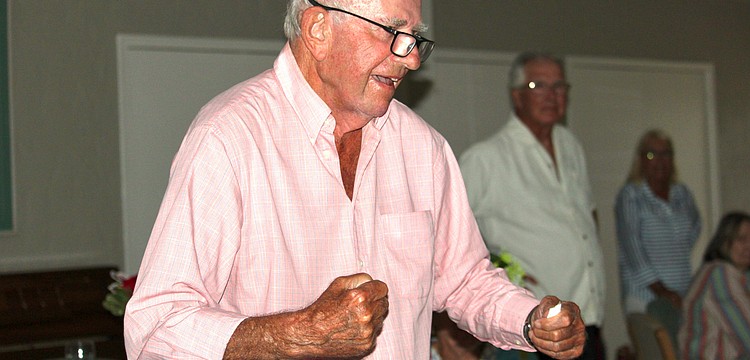 Don Schultz of Windward Bay celebrates as his top pick, Golden Tempo, crosses the finish line first at the Kentucky Derby. Schultz was the only person at the watch party to pick the long-shot horse.