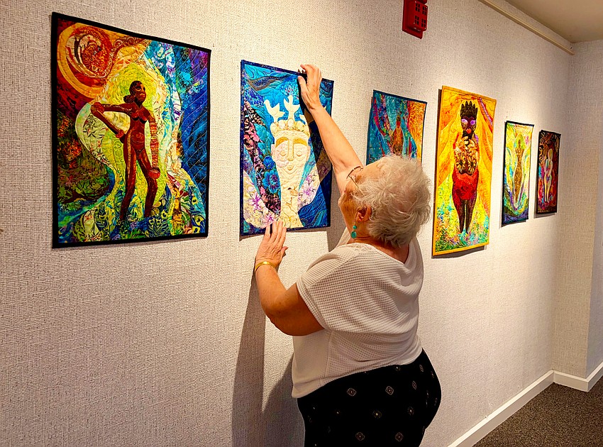 Quilt artists lays out her series of works on ancient goddesses. The gallery will be open to the public through the end of June.