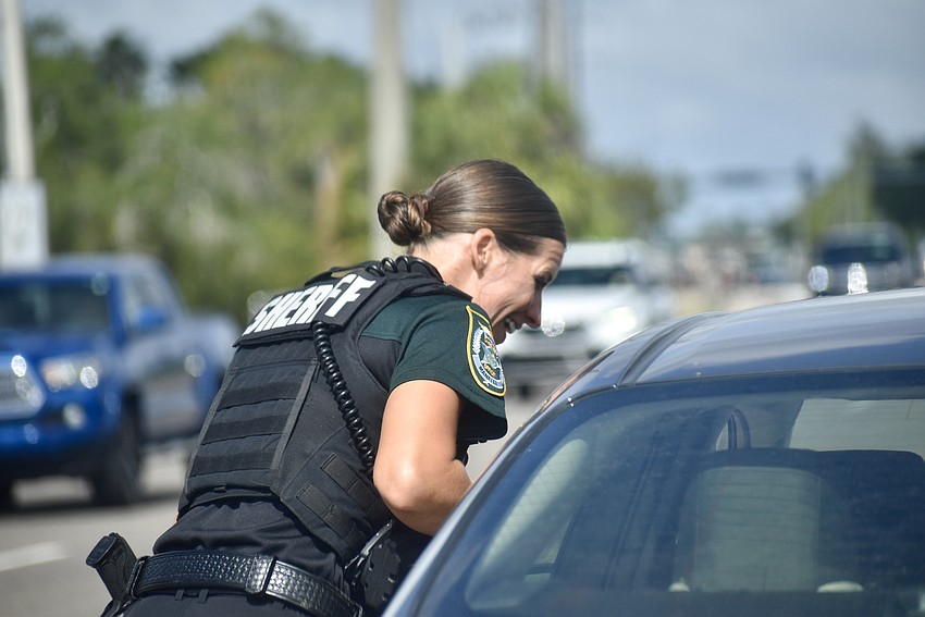 Deputy Sarah Brown hands out tickets with a smile.