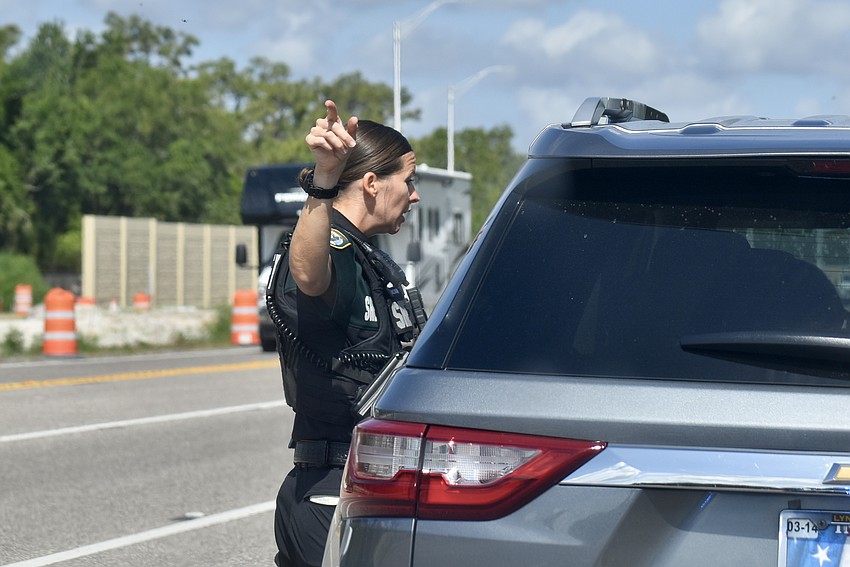 Deputy Sarah Brown points out construction workers to a driver speeding in a construction zone.
