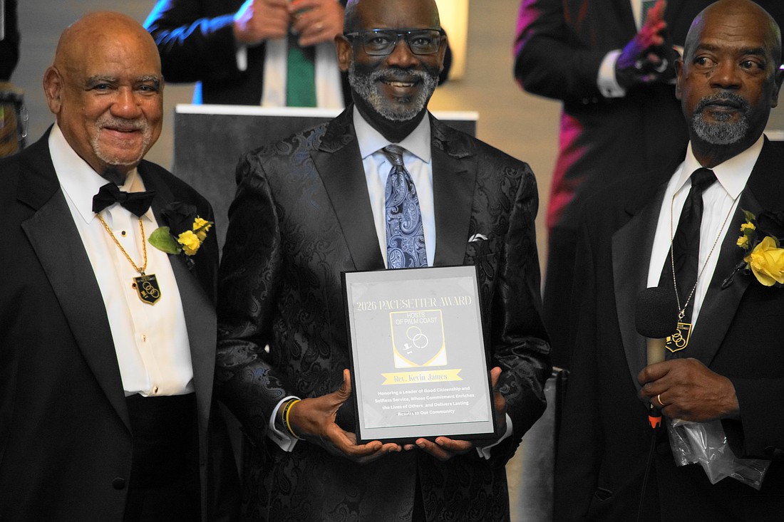 Rev. Kevin James (center) receives a 2026 Pacesetter Award from the Hosts of Palm Coast. Courtesy photo