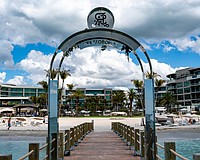 The St. Regis Longboat Key Resort installed a stainless steel arch on a private groin, leading to a lengthy dispute with the town of Longboat Key, with leaders claiming it violate’s the town’s sign code.