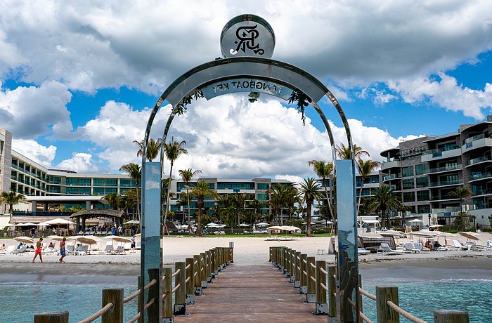 The St. Regis Longboat Key Resort installed a stainless steel arch on a private groin, leading to a lengthy dispute with the town of Longboat Key, with leaders claiming it violate’s the town’s sign code.