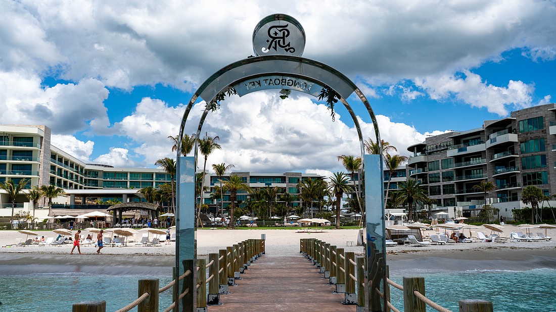 The St. Regis Longboat Key Resort installed a stainless steel arch on a private groin, leading to a lengthy dispute with the town of Longboat Key, with leaders claiming it violate’s the town’s sign code.
