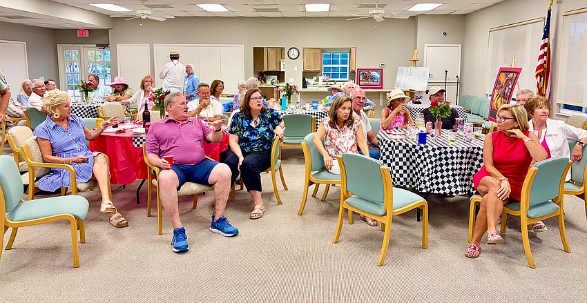 Windward Bay watch party attendees debate their top picks before the Kentucky Derby race starts.