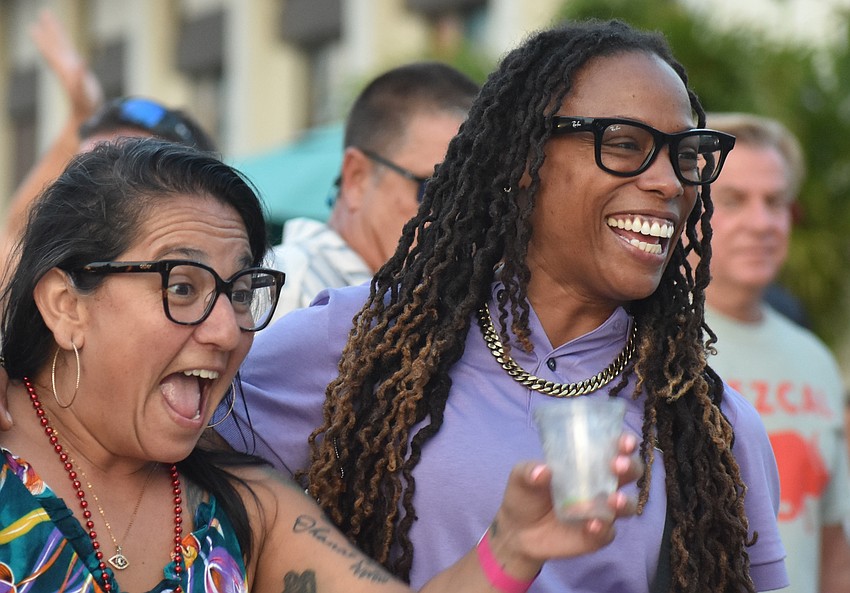 Palmetto's Maria Gil and East Bradenton's Kamille Bratton watch the band Jah Movement perform during the Cinco de Mayo celebration at Agave Bandido.