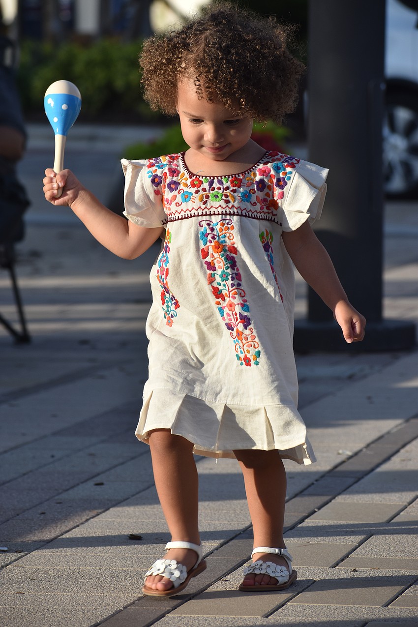 Parrish's Skyla Rodriguez, 2, loves music and dances with a maraca in hand at the Cinco de Mayo celebration.
