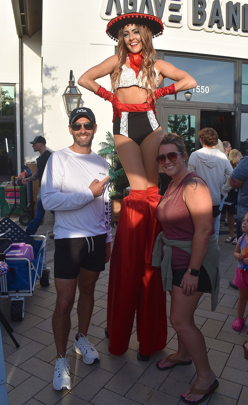 Prism Artistry's Nicole Grannie (on stilts) is joined by Lakewood Ranch's Joshua Potts and Ashley Taylor for a photo at the Cinco de Mayo celebration at Agave Bandido.