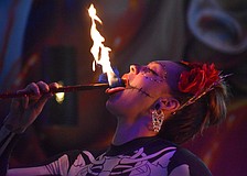 Alannis Peterson of Prism Artistry "eats" fire at Agave Bandido for its Cinco de Mayo Celebration May 5.