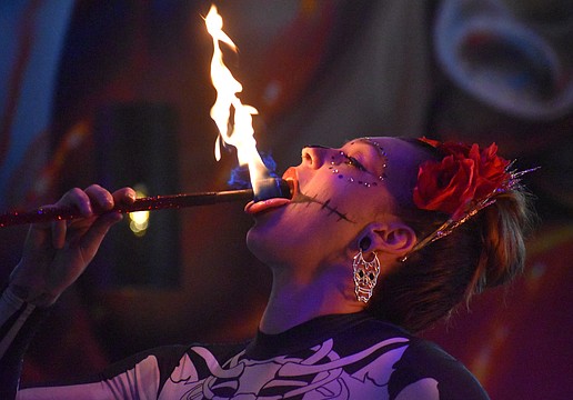 Alannis Peterson of Prism Artistry "eats" fire at Agave Bandido for its Cinco de Mayo Celebration May 5.