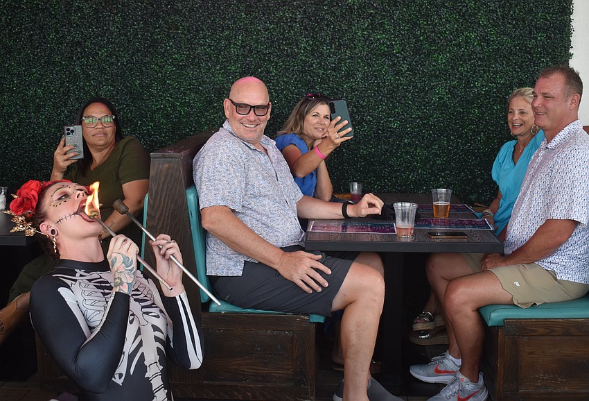 Agave Bandido customers Arelys Huertas, David Lurvey, Angela Lurvey  Heather Evans and Bart Evans watch as Alannis Peterson of Prism Artistry 