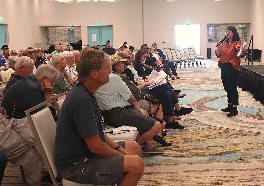 Local land use attorney Jessica Gow discusses the Halifax Community Center plans with neighboring residents at a May 4 neighborhood meeting. Photo by Sierra Williams