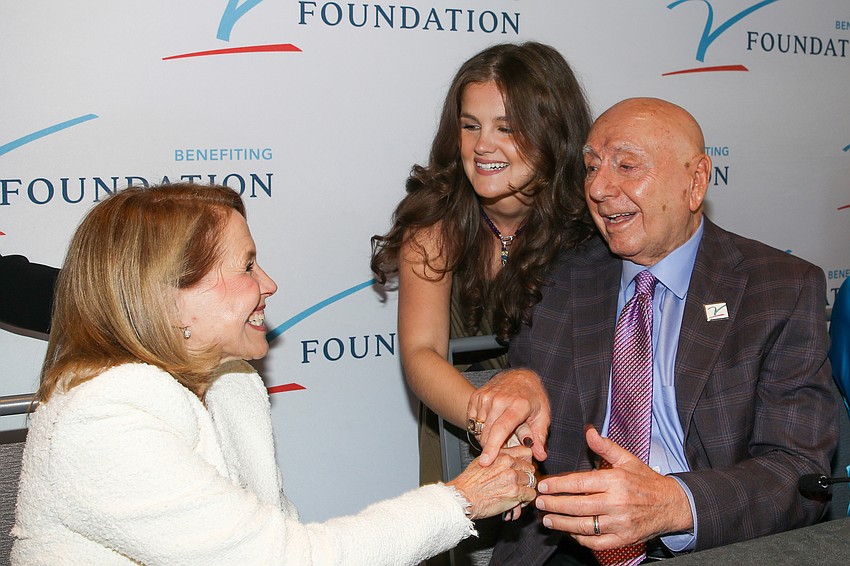 Katie Couric (left), Tatum Parker (top right) and Dick Vitale (bottom right) exchange some smiles. Parker, who beat pediatric cancer twice, now runs the 