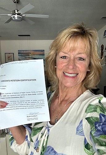 Flagler County commission candidate Anna Jones holds up her petition certification signed by Flagler County Supervisor of Elections Kaiti Lenhart. Courtesy photo