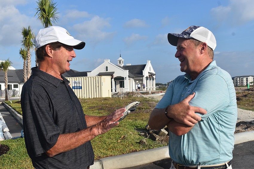 Lakewood Ranch's George Prince and David Stuhlfire exchange stories at Calusa Country Club prior to their participation in the Lakewood Ranch Community Foundation Golf Tournament.