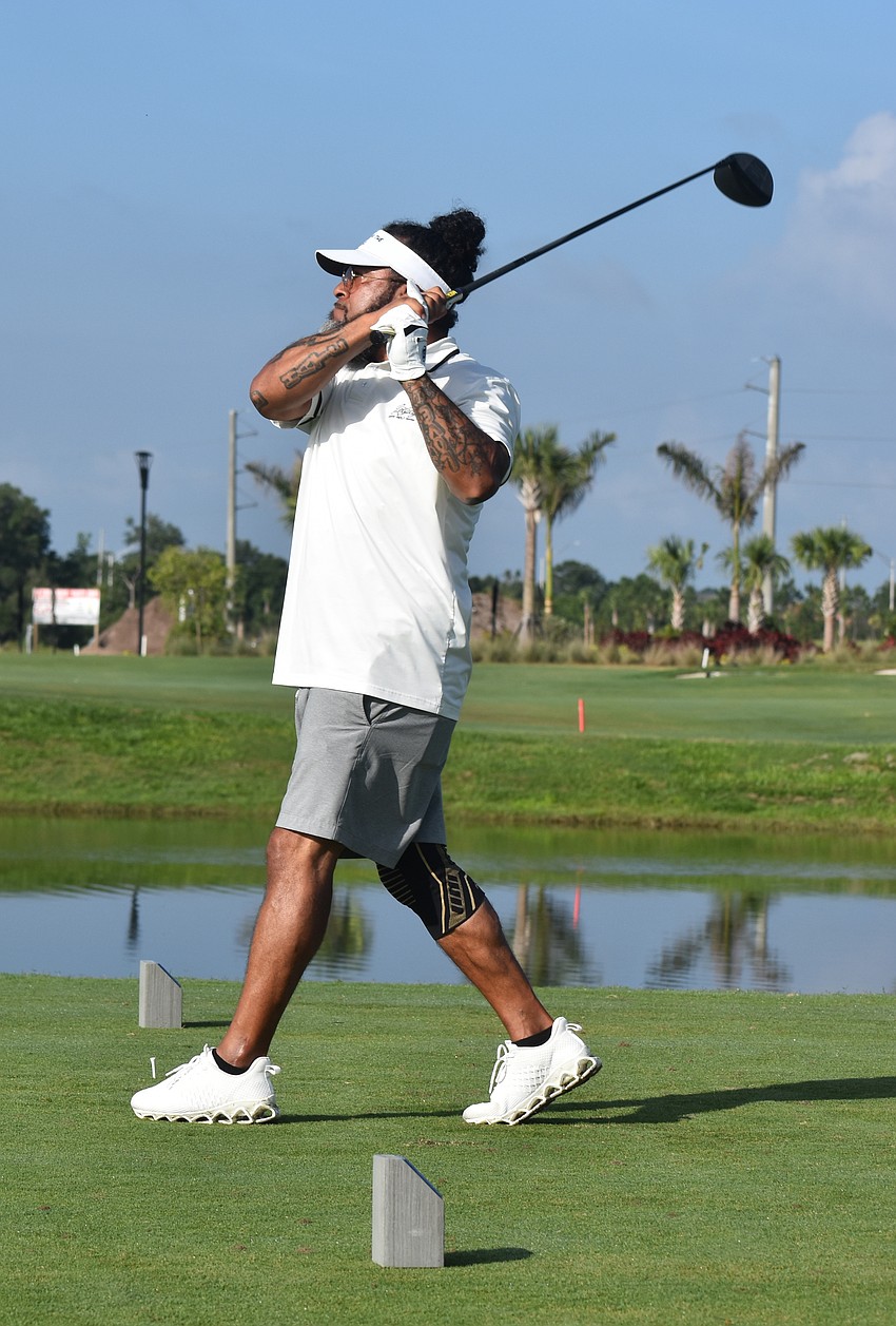 Bradenton's Eddie Enriquez watches the flight of his ball during the Lakewood Ranch Community Foundation Golf Tournament at Calusa Country Club May 8.