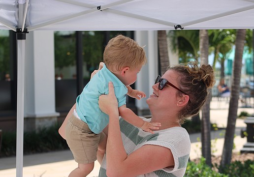 Parker Hippich, 12 months, gets a lift from mom, Tessa Hippich, during Petals and Poses on Saturday at Waterside Place.