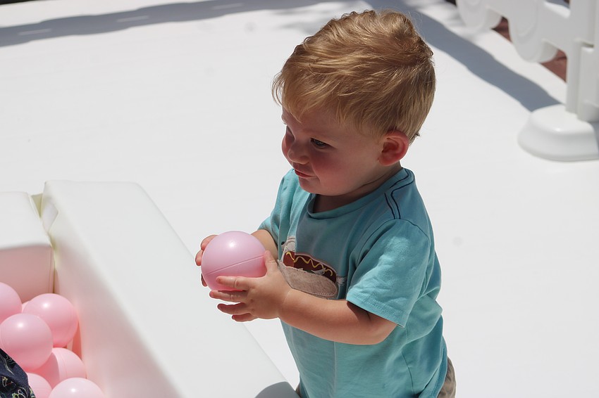 Heritage Harbour's Parker Hippich, 12, is having a ball in the kids' zone at the Petals and Poses event Saturday at Waterside Place.