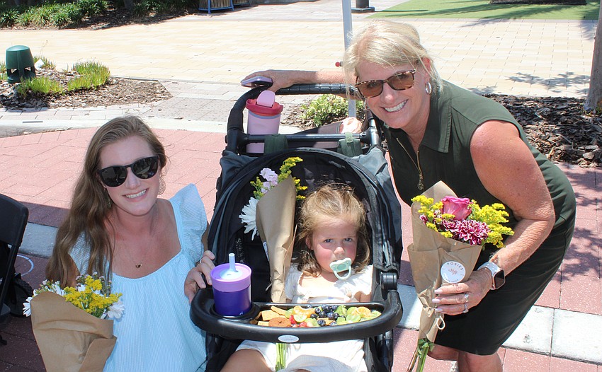 Mom Mariah Cason and grandma Juanita Tiona bring Eloise Cason to the Petals and Poses event at Waterside Place Saturday.