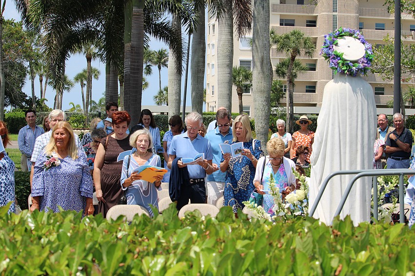 Attendees of the May crowning ceremony on Mother's Day at St. Mary, Star of the Sea, Catholic Church, close out the morning service with a song.