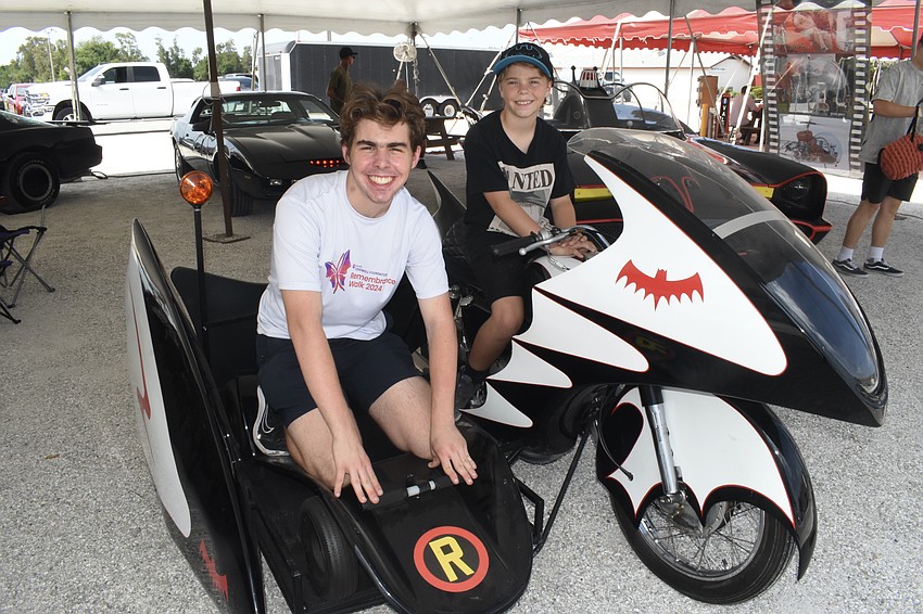 Garrett Nock, 17, and his brother Easton Nock, 11, ride the Batcycle from the 1966 