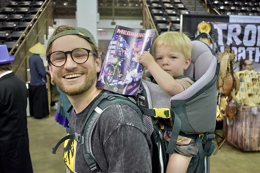 Shiloh Reeves carries along his son his son Rowan Reeves, 1, who loves comic books.