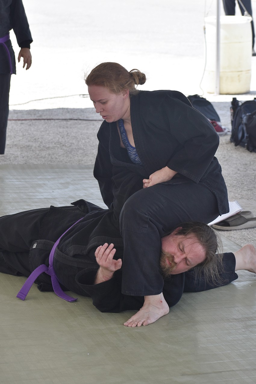 Elizabeth Hall takes down Joel Mimbs in a Jujutsu demonstration by Cypress Pillar Healing Arts.